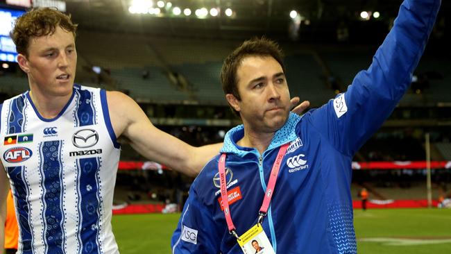 Kangaroos coach Brad Scott waves to fans after the Round 10 AFL match between the Western Bulldogs.