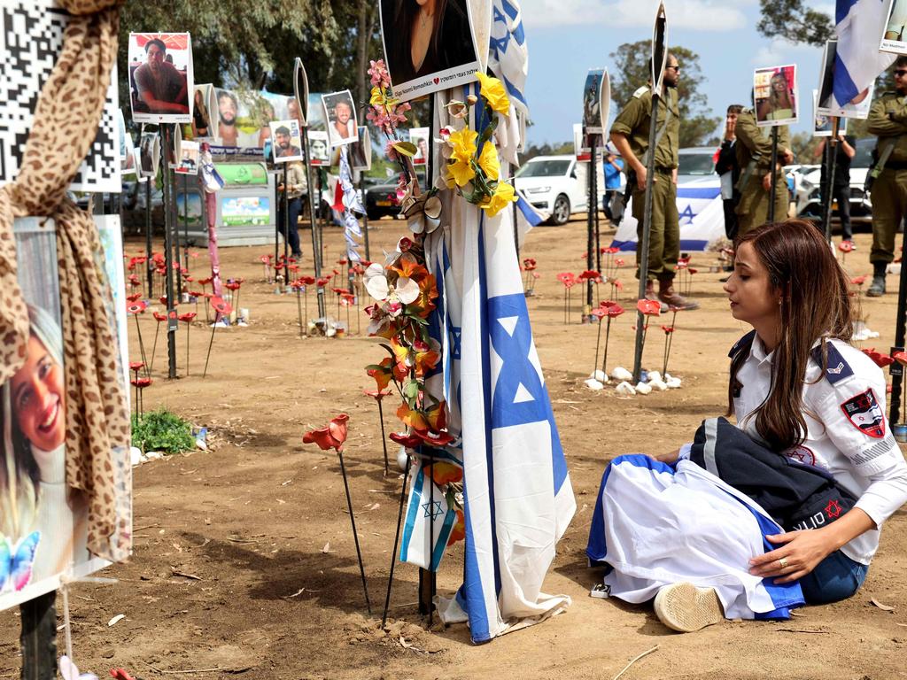 A visitor mourns at a memorial for people who were taken hostage or killed in the Hamas attack on the Supernova music festival on October 7. Picture: AFP