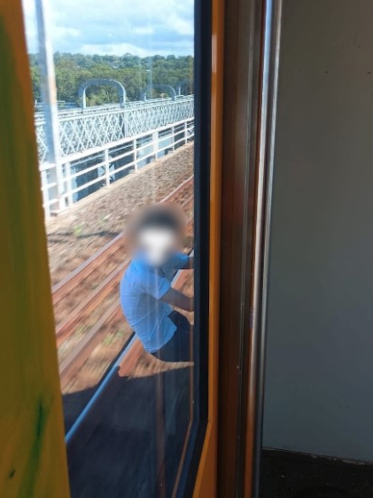 The boy is clinging onto the train as it crosses the Como Bridge in Sydney's south. Picture: Facebook.