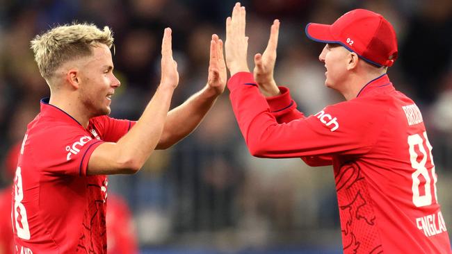 Sam Curran and Harry Brook of England celebrate their victory in the first cricket match of the Twenty20 warm-up series between Australia and England.