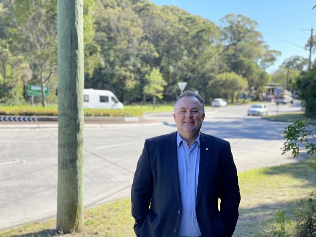 Terrigal State Liberal MP Adam Crouch at the roundabout at Tumbi Rd and Central Coast Highway which will be upgraded to traffic lights. Picture: Richard Noone