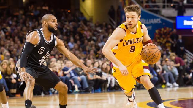 Aussies Patty Mills (left) and Matthew Dellavedova go head-to-head in the NBA.