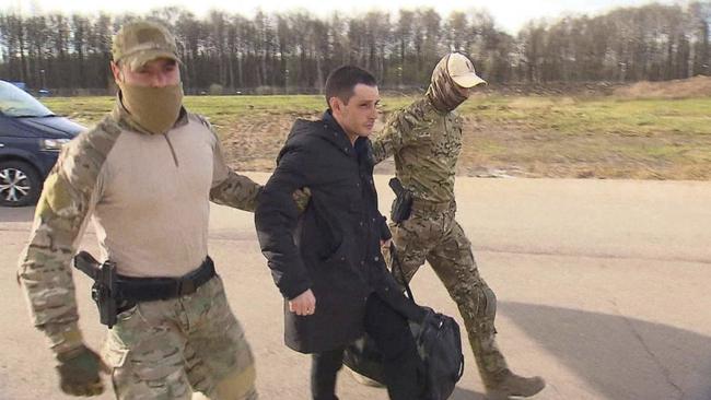 Trevor Reed is escorted to a plane in Moscow on Wednesday. Picture: Reuters