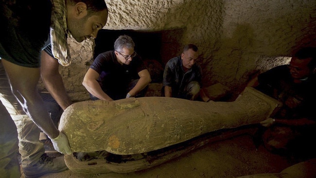 Mostafa Waziry, right, inspecting one of thirteen 2500 year-old wooden coffins discovered in a burial shaft at the desert necropolis of Saqqara in 2020. Picture: AFP