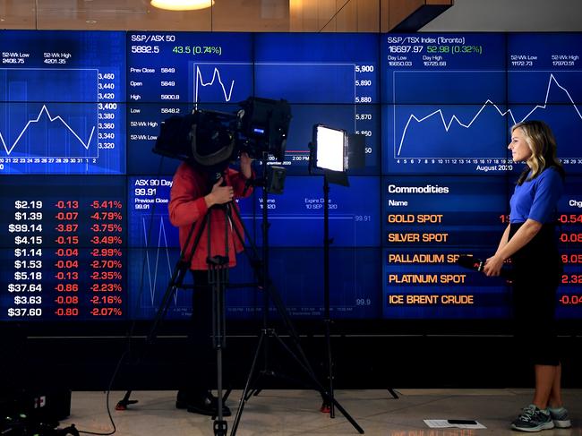 SYDNEY, AUSTRALIA - NCA NewsWire Photos SEPTEMBER, 03, 2020: A news crew reports in front of digital market boards at the Australian Stock Exchange (ASX) in Sydney. Picture: NCA NewsWire/Joel Carrett