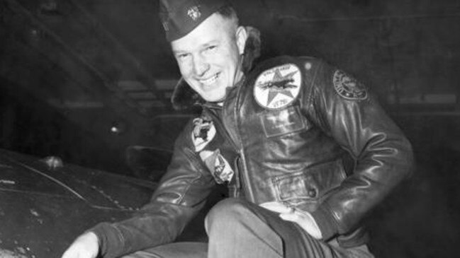 Lt. Royce Williams, USN, points out battle damage to his F9F-5 Panther after a firefight with Russian migs.