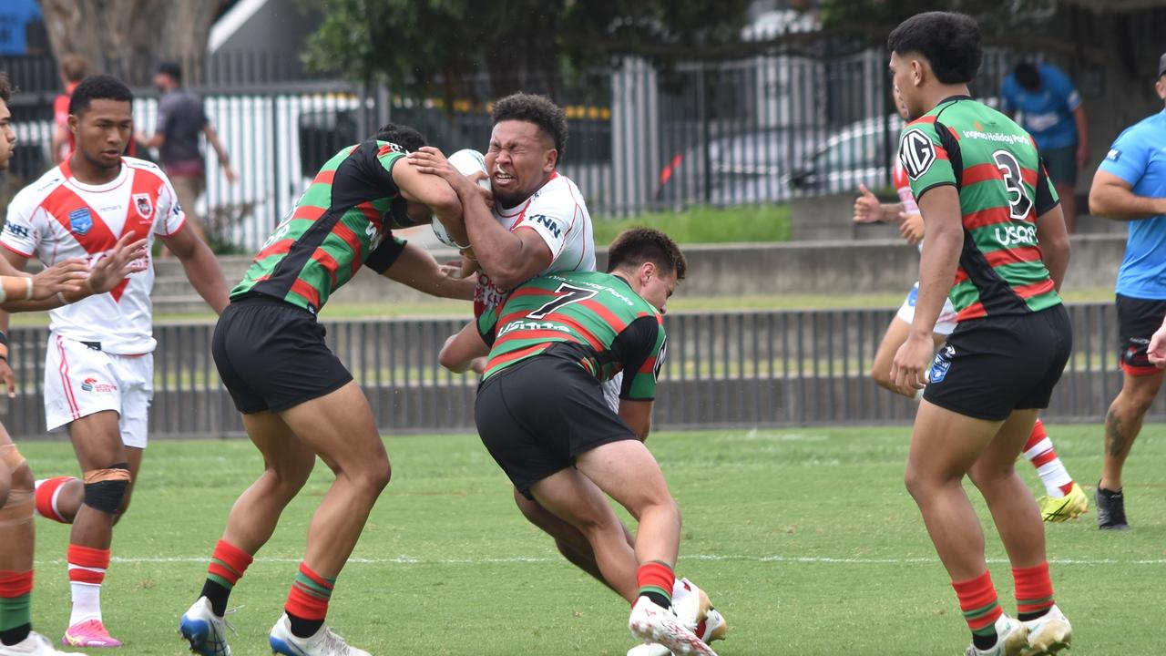 Cyrus Stanley-Traill is tackled by Tylah Slate (left) and Matthew Humphries. Picture: Sean Teuma