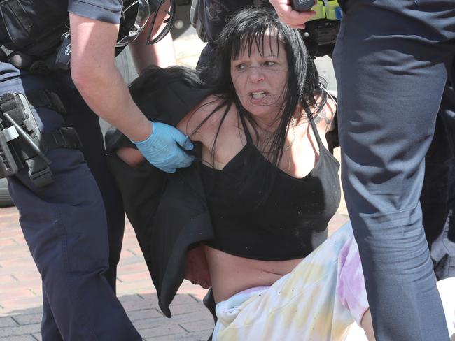 Police with Lauran Howe after she crossed the tape. Picture: David Crosling