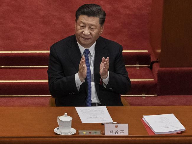 BEIJING, CHINA - MAY 28: Chinese president Xi Jinping, applauds the results of a vote on a new draft security bill for Hong Kong during the closing session of the National People's Congress on May 28, 2020 in Beijing, China. The Chinese government passed the draft by a vote of 2,878 votes to one during the session. The draft law, which has drawn international concern, is set to address issues such as secession, subversion, terrorism, and foreign interference, and comes after a year of anti-government protests in the semi-autonomous region. China held its annual parliamentary gathering, known as 'The Two Sessions', at the Great Hall of the People from May 21-28th after being postponed at the height of the coronavirus outbreak in China earlier this year. (Photo by Kevin Frayer/Getty Images)