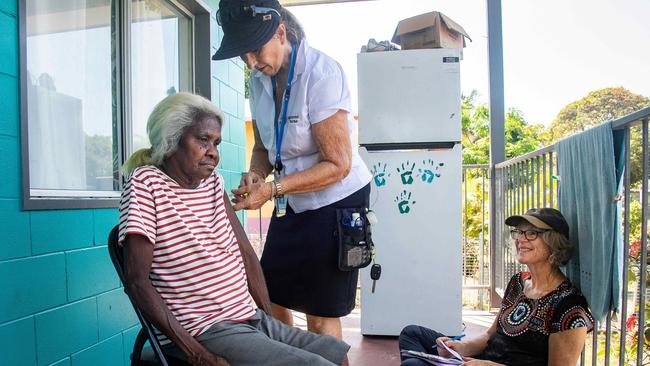 Leanne Bulmer, 67, recieves the Pfizer vaccine on the verandah of her home from nurse Susie Jarman, watched by Dr Joy Linton. Picture: Brian Cassey