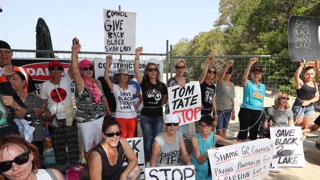 Black Swan Lake protest at Bundall goes to another level, with protesters chaining themselves to the fence and then getting arrested. Picture Glenn Hampson.