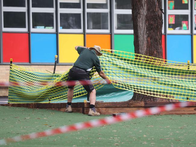 Staff fencing off the mulch at Allambie Heights Public School yesterday. Picture: Tim hunter.