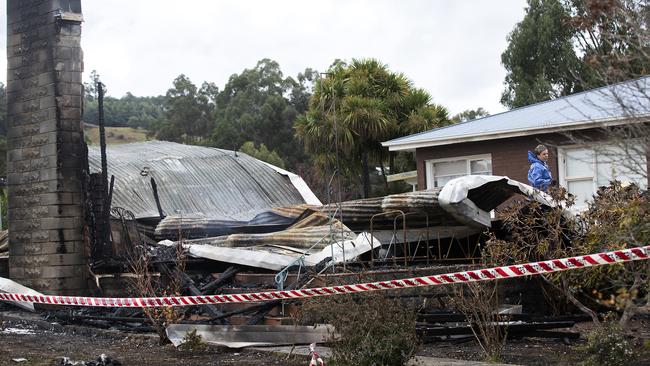 Police and fire investigators at the scene of a house fire at Fourfoot Rd, Geeveston. Picture Chris Kidd