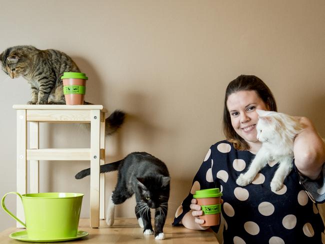 Anita Loughran enjoys a coffee alongside furry companions in Melbourne. Picture: Jason Edwards