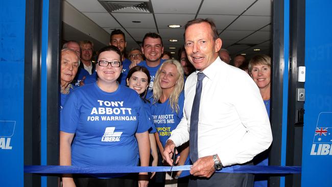 Tony Abbott cutting a ribbon to Brookvale campaign office launch. Picture Jonathan Ng