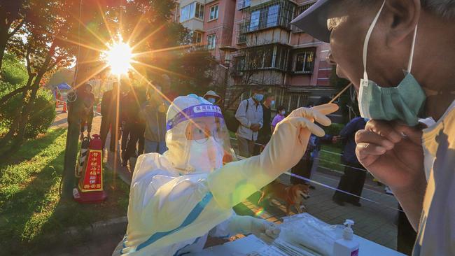 A health worker takes a swab sample from a man to be tested for the Covid-19 coronavirus in China's northern Tianjin. Picture: AFP