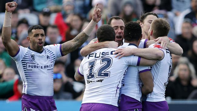 Justin Olam celebrates a try with his Storm teammates. Picture: AAP