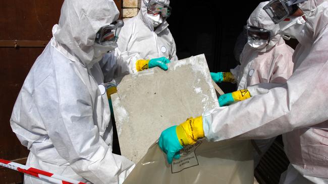 "Staff removing some asbestos in a post of transformer, Reflection of mask of man opposite was created for cannot be recognised" Picture: iStock