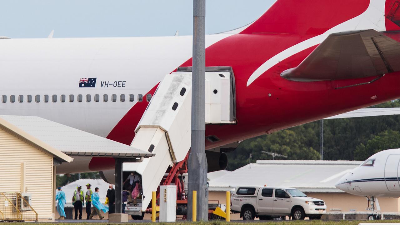 Australian evacuees from the coronavirus-struck cruise ship Diamond Princess deplane a Qantas flight from Japan at Darwin International Airport in Darwin. Picture: AAP/Helen Orr