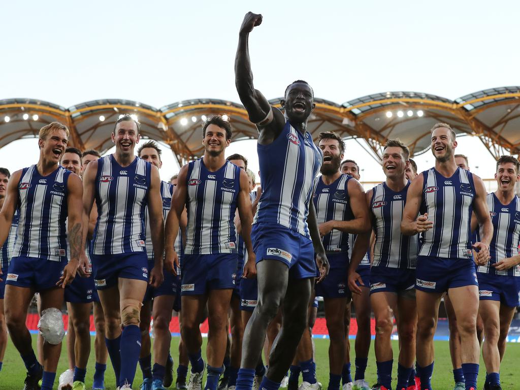 Majak Daw leads the Kangaroos off the field after his first game back.