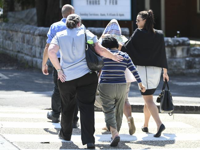 Relatives and business colleagues walk from the court after hearing outside Sutherland Court. 