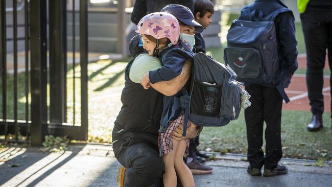 Gavin Sheppard hugs daughter Evelyn, 6, at the school gate. Picture: Wayne Taylor