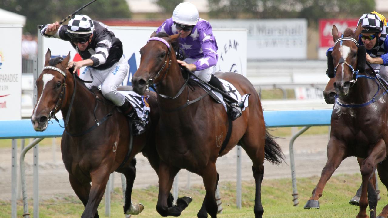 Finish and returns from Gold Coast turf club Race 5, the BMW Magic Millions Classic. No Looking Back with Nash Rawiller aboard shifts out on Driefontein and jockey Tom Berry near the winning post.