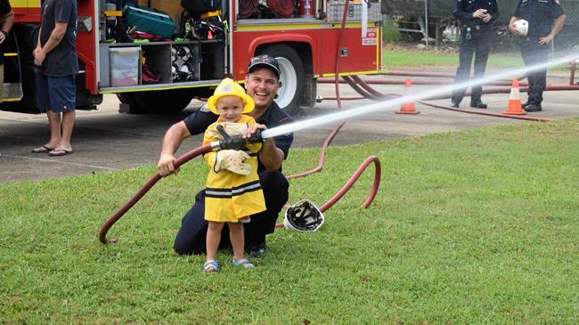 TOO CUTE: Future firefighter Abel Vuk was chuffed when firefighter Dave Gibson showed him the ropes. Picture: Claudia Alp