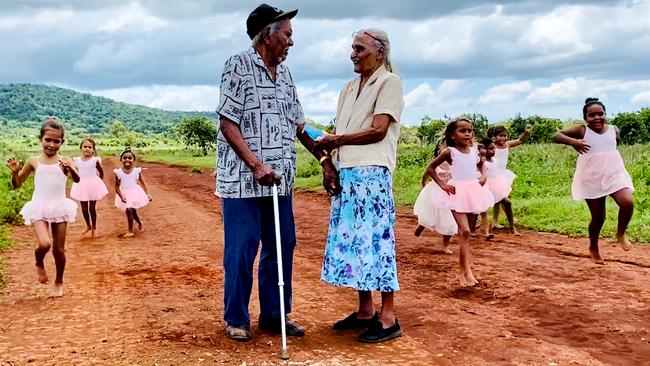 Guugu Yimithirr elder Ella Woibo, 88, and her husband Frank, 93, surrounded by Hope Vale’s barefoot ballerinas, including two of their great-grandchildren. Picture: Peter Michael