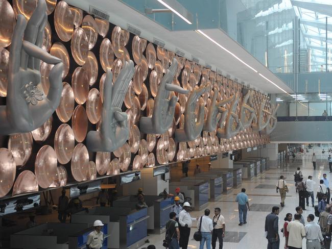 TO GO WITH India-economy-airport-infrastructure FOCUS by Penny MacRae (FILES) In this file photo taken on June 23, 2010, Indian people inspect the newly-built Terminal 3 building of the Indira Gandhi International Airport in New Delhi. Frequent travellers to India are in for quite a shock the next time they fly in to New Delhi's international airport with its new multi-billion-dollar, state-of-art terminal. For years, arrivals at Delhi's main airport were greeted by the sight of dingy walls, dim lighting, congested counters and the smell of overflowing toilets when they ventured into washrooms. Now with the new Terminal 3, a futuristic, 2.7-billion-dollar facility in glass-and-steel, the capital finally has a showcase airport that chimes with the India's global aspirations. AFP PHOTO/RAVEENDRAN/FILES Picture: Afp