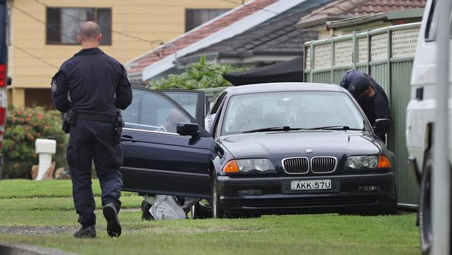 Police are searching a car at the possible address of a man arrested earlier walking the streets with a balaclava and rifle. Picture: Richard Dobson