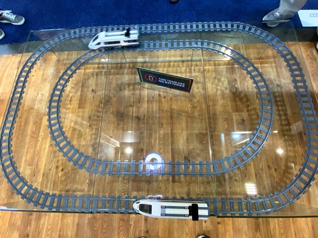 Wi-Charge demonstrates an electric train set that runs on power transmitted by infrared laser. There are no batteries or power cord.