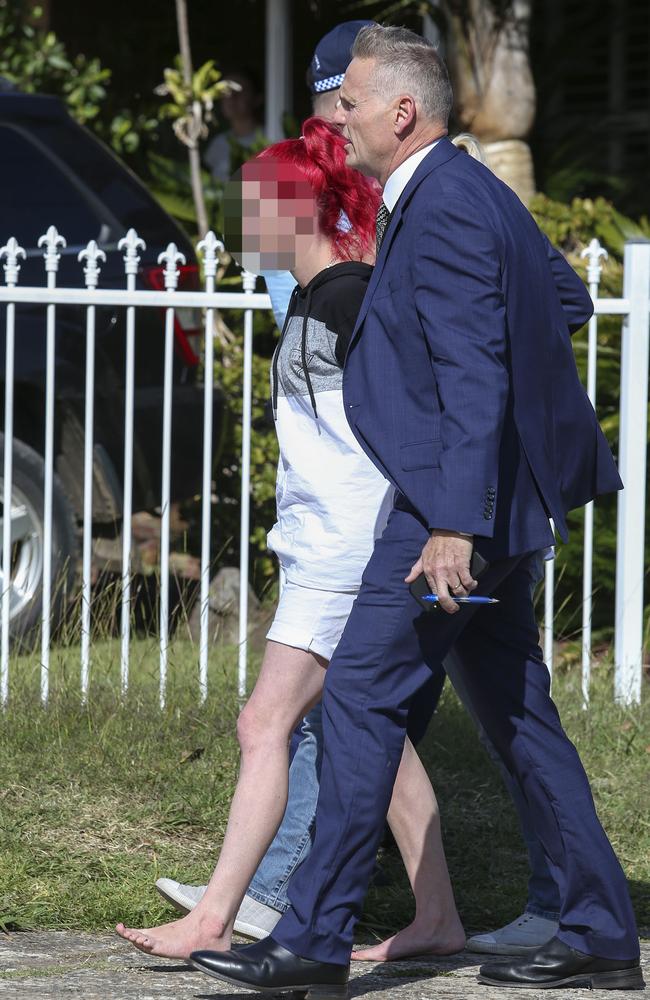 A woman is also accompanied from the Gipps Rd, Greystanes, Sydney, where they arrested three people this afternoon. Picture: Justin Lloyd