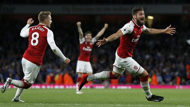 Arsenal's French striker Olivier Giroud (C) celebrates scoring Arsenal's fourth goal during the English Premier League football match between Arsenal and Leicester City at the Emirates Stadium in London on August 11, 2017. / AFP PHOTO / Ian KINGTON / RESTRICTED TO EDITORIAL USE. No use with unauthorized audio, video, data, fixture lists, club/league logos or 'live' services. Online in-match use limited to 75 images, no video emulation. No use in betting, games or single club/league/player publications.  /