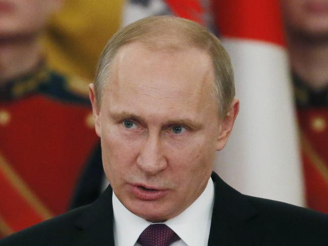 Russian President Vladimir Putin (C) speaks during a ceremony of presenting jubilee medals in honor of the 70th anniversary of the victory in the World War II to WWII veterans in the St. George Hall of the Grand Kremlin Palace in Moscow on February 20, 2015. AFP PHOTO / POOL / SERGEI ILNITSKY