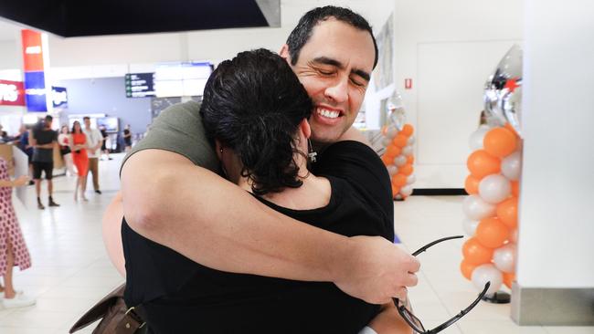 Yonni Paul bursts into tears after seeing his wife Carlina Paul for the first time in six months after he arrived in Queensland the first flight from Sydney. Picture: Scott Powick / News Corp