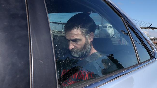 Matthew Tilley is seen with police leaving the Adelaide Airport in Adelaide in September 2019.