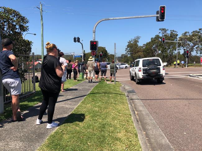 A group of onlookers gathered at the northern end of Minnesota Rd, Hamlyn Terrace, at the intersection of Warnervale Rd, watching after a pursuit and shooting. Picture: Richard Noone