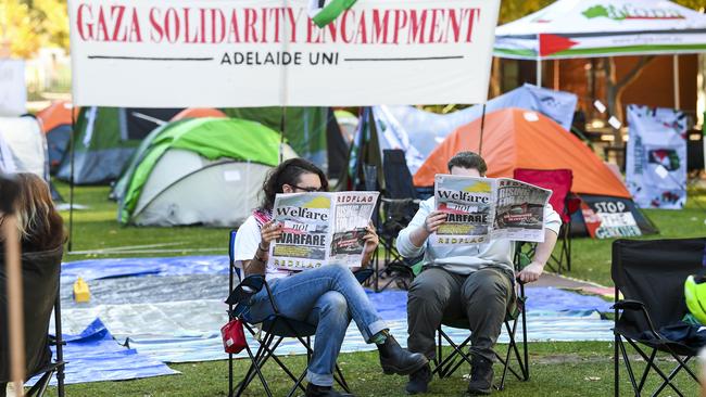 Students read the uni paper. Picture: Mark Brake