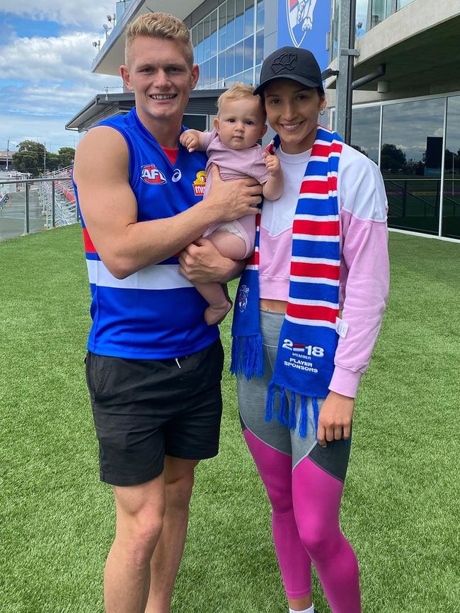 Adam Treloar with wife Kim Ravaillion and daughter Georgie.