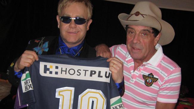 Elton John and Molly Meldrum make up backstage.