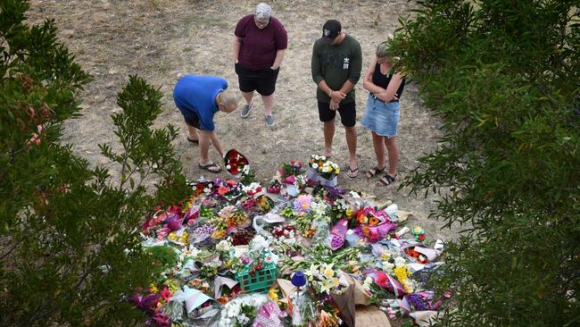 People lay tributes at the site where Aiia Maasarwe was murdered. Picture: Tony Gough