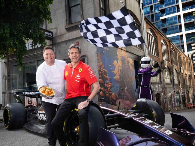 Next years Melbourne F1 race will expand to take over the streets and lanes of the CBD. Lord Mayor Nick Reece and Damian Snell with an F! Car at Flinders Lane. Picture: Tony Gough