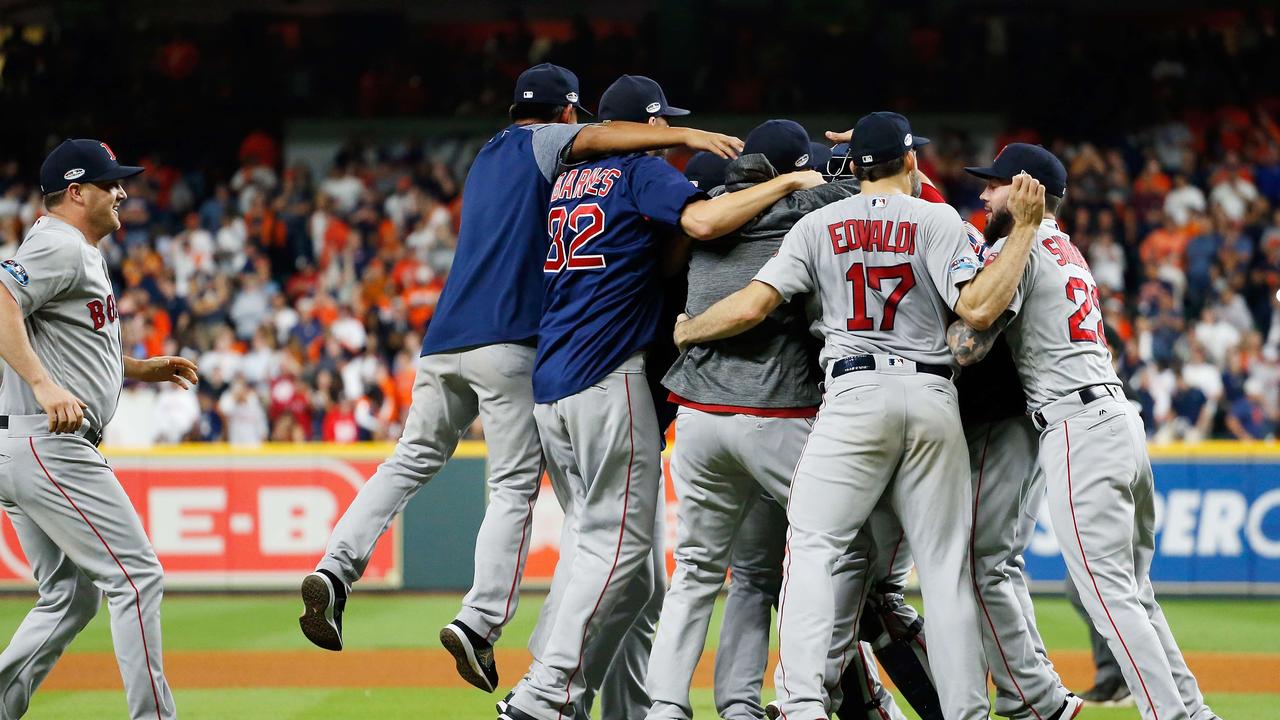 The Boston Red Sox celebrate defeating the Houston Astros 4-1 in Game Five of the American League Championship Series to advance to the 2018 World Series.