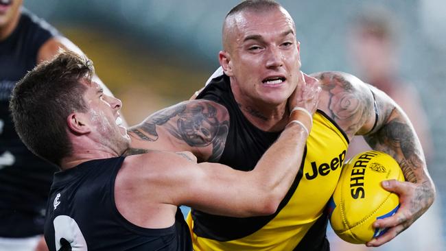 Marc Murphy tries to collar Richmond star Dustin Martin in Round 1.