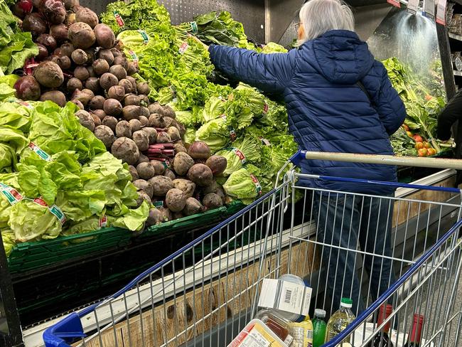 A woman buyS vegetables at a supermarket in Buenos Aires on May 23, 2024. Argentina's economic activity continued to plummet in March, with the construction and manufacturing industries leading the slowdown as President Javier Milei's government slashes spending, official figures showed Wednesday. (Photo by STRINGER / AFP)