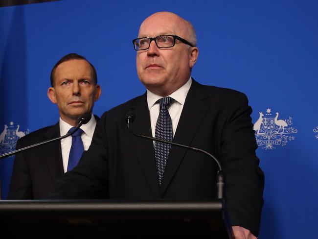 Back down: Prime Minister Tony Abbott with the Attorney General George Brandi. Photo: Gary Ramage