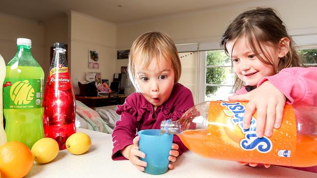 Yumi, 2 and Coco, 4, aren’t fooled by the labels. They just like the taste. Picture: Tim Carrafa