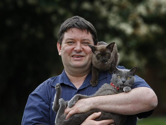 Vet Andrew Redmond and a couple of cats.
