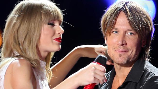 Taylor Swift is joined on stage by Tim McGraw and Keith Urban for the first night of the CMA festival. The powerhouse trio performed at the LP Field in Nashville,TN during the first of four nights of the Country Music Association Festival. Pictured: Taylor Swift, Tim McGraw and Keith Urban Ref: SPL556901 060613 Picture by: Dean Chapple /AJ/ Splash News Splash News and Pictures Los Angeles: 310-821-2666 New York: 212-619-2666 London: 870-934-2666 photodesk@splashnews.com